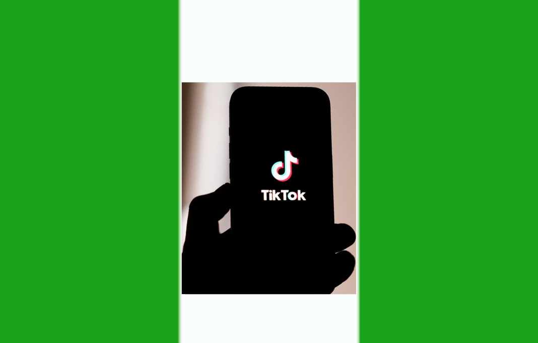 Nigerian youth using TikTok on phone