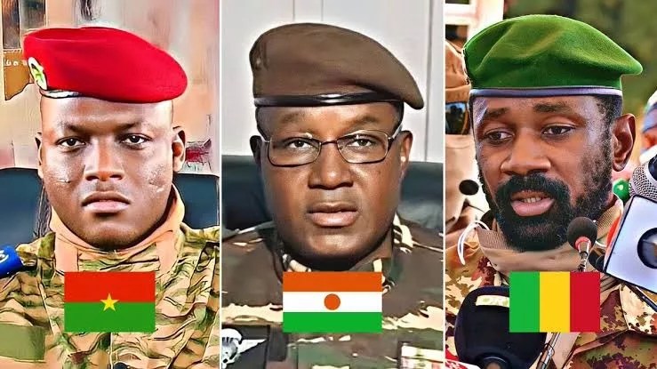 Leaders of Burkina Faso, Mali, and Niger — Capt. Ibrahim Traoré, Col. Assimi Goïta, and Gen. Abdourahamane Tchiani — shown in a symbolic joint press moment announcing their withdrawal from the International Criminal Court, with flags of their nations and documents labeled “Rome Statute Withdrawal” on the table.