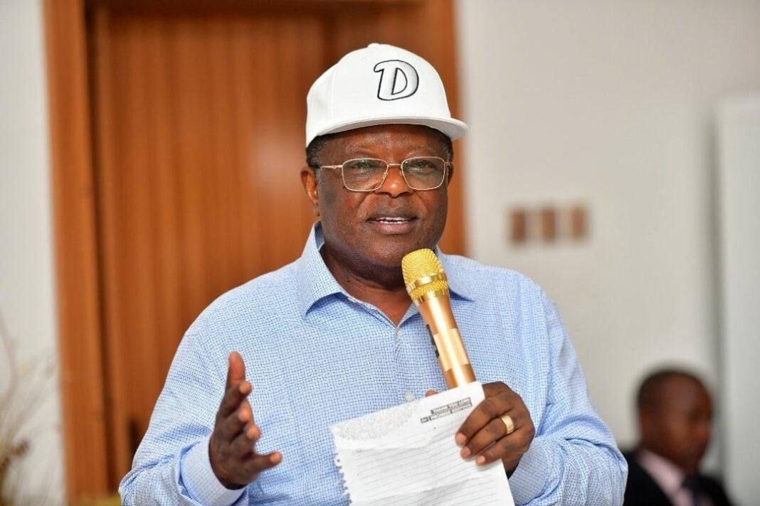 Federal Works Minister David Umahi speaking during an inspection of the Abuja-Mararaba-Keffi road alongside Nasarawa State Governor Abdullahi Sule, with construction activity visible in the background.