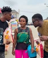 Nigerians holding a sack of rice branded with Tinubu pictures, symbolizing the Ricegeria satire on governance and palliatives under the Tinubu administration.